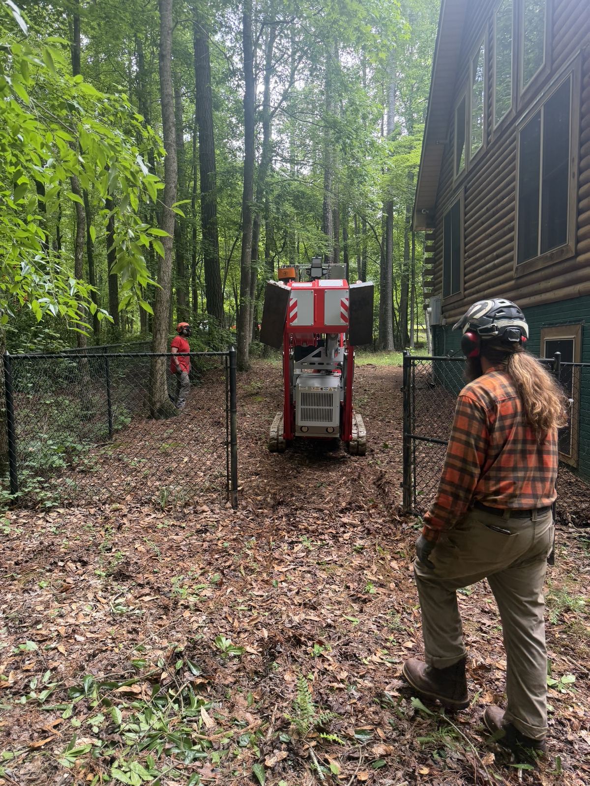 Tracked lift going through a narrow side-yard gate